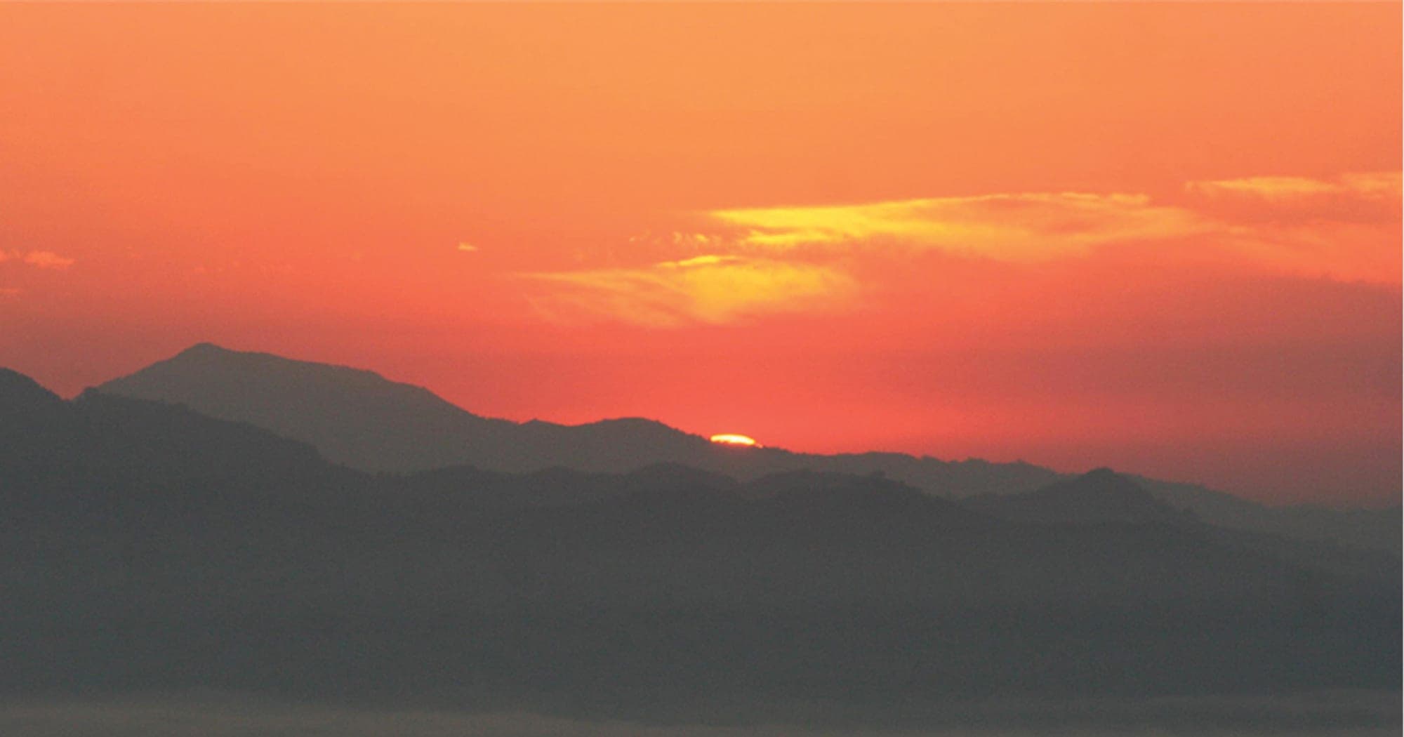 Sunrise over layered Himalayan ridges